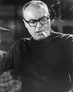 Headshot of American film director John Sturges wearing a black turtleneck and glasses with a cigarette dangling from his lips and smoke swirling up Black Turtleneck, Bw Photo, The Magicians, Filmmaking, A Black, Cool Pictures, Swirl