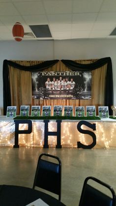 an image of a sports themed party with lights on the table and pictures hanging from the ceiling