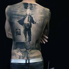 the back of a man's body is shown with an image of jesus on it