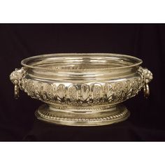 an ornate silver bowl on a black background