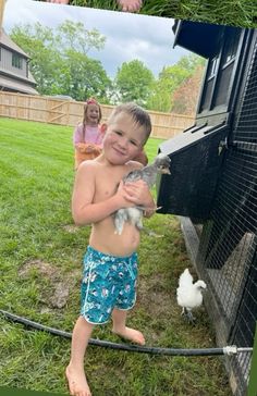 a little boy that is standing in the grass with a bird on his arm and another kid behind him