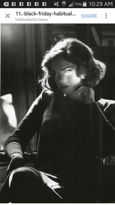 black and white photograph of a woman sitting in a chair with her hand on her chin