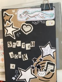 a clipboard with writing on it that says scratch book 4 and has various stars