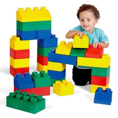 a little boy playing with some colorful blocks