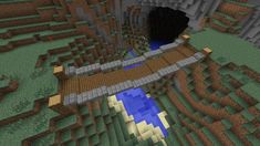 an image of a bridge in the middle of a minecraft area with trees and rocks