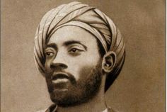 an old photo of a man wearing a turban and looking off to the side