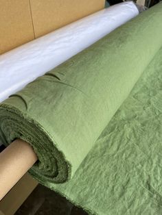 a roll of green fabric sitting on top of a table