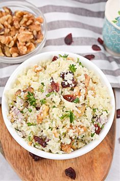 a white bowl filled with rice and nuts