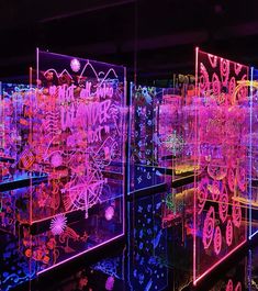 an art installation with neon lights in the dark