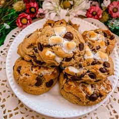 a white plate topped with cookies and marshmallows