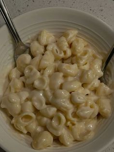 a white bowl filled with macaroni and cheese