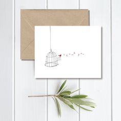 a card with the words love is in a birdcage hanging from a branch