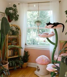 a living room filled with lots of plants and stuffed animals on the windowsills