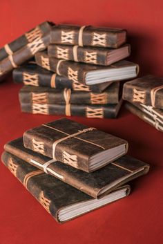 a pile of leather journals against a red background Handmade Leather Journal, Handmade Leather, Leather Handmade, Notebook