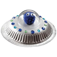 a blue ballon with eyes and nose on top of a silver foil plate