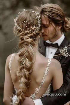 a man in a tuxedo and a woman in a wedding dress are embracing each other