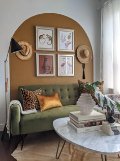 a living room filled with lots of furniture and pictures on the wall above it's coffee table