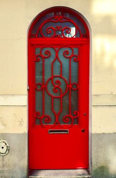 a red door with iron bars on it