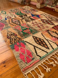 a multicolored rug with fringes on the floor