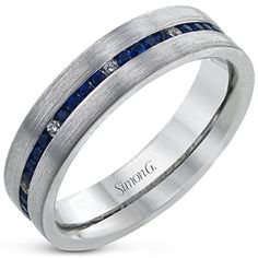 a men's wedding band with blue sapphires and white gold in the center