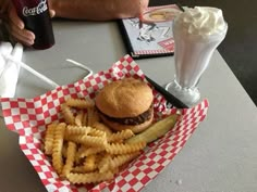 a hamburger and french fries on a table