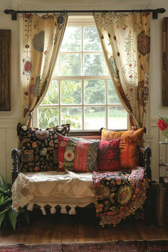 a couch sitting in front of a window filled with pillows