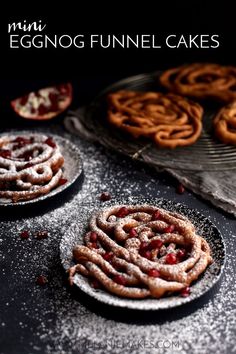 some cookies are sitting on top of a table with powdered sugar and cranberries