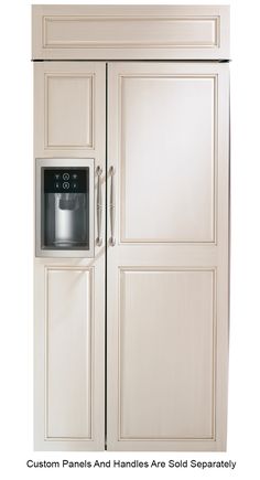 a white refrigerator freezer sitting inside of a wooden cabinet next to a wall mounted clock