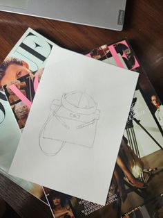 some magazines and a drawing on a table