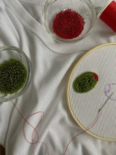 two bowls filled with beads and thread next to each other