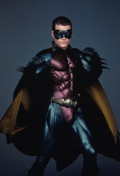 a man in a batman costume with his hands on his hips