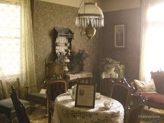 an old fashioned dining room with table and chairs