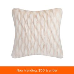 a white fur pillow with the words now trending $ 50 & under on it