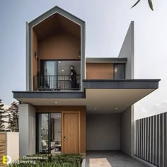 a modern house with an open balcony and large windows on the top floor is shown