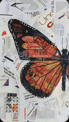 a butterfly is sitting on top of some newspaper pages and it's wings are spread out