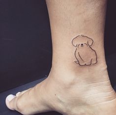 a small dog tattoo on the ankle