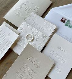 an assortment of wedding cards and envelopes on a table