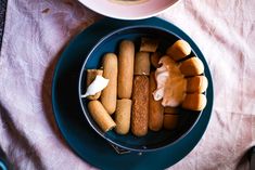 a blue plate topped with food next to a cup of coffee