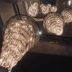 a chandelier hanging from the ceiling in a room with several lights on it