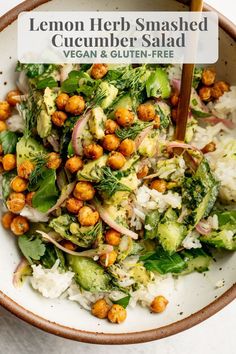 a white bowl filled with vegetables and garnished with chickpeas on top