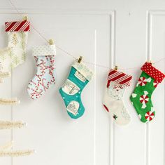 christmas stockings hanging on the wall with decorations