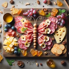 a wooden tray topped with lots of different types of cheeses and crackers on top of a table