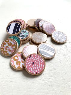 a pile of wooden buttons sitting on top of a white table