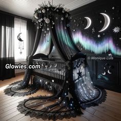 a canopy bed with stars and moon decorations on it