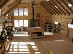 an attic with wood floors and lots of windows