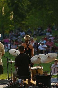 a group of people that are standing in front of some drums