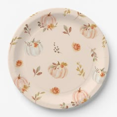 a paper plate decorated with pumpkins and flowers on it's side, against a white background