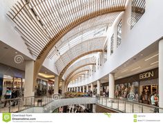 the inside of a shopping mall filled with people