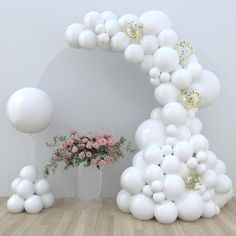 a bunch of balloons that are in the shape of an arch with flowers on it