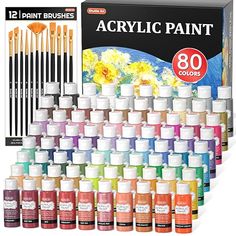 12 different colors of acrylic paint are shown in front of a box with the contents